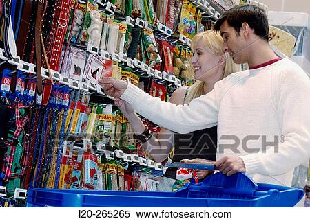 Couple looking at electronic price displays at the pets section of Eroski shopping center. These displays are updated by remote control. Urbil. Usurbil. Guipuzcoa. Basque Country. Spain View Large Photo Image Stock Photography - Couple looking at electronic price displays at the pets section of Eroski shopping center. These displays are updated by remote control. Urbil. Usurbil. Guipuzcoa. Basque Country. Spain. Fotosearch