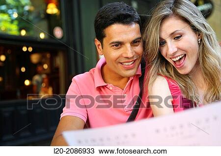 Couple looking at menu in the restaurant. San Sebastian. Donostia. Gipuzkoa. Basque Country. Spain. View Large Photo Image Stock Image - Couple looking at menu in the restaurant. San Sebastian. Donostia. Gipuzkoa. Basque Country. Spain.. Fotosearch
