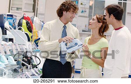 Couple looking for an iron at shopping center View Large Photo Image Stock Image - Couple looking for an iron at shopping center. Fotosearch