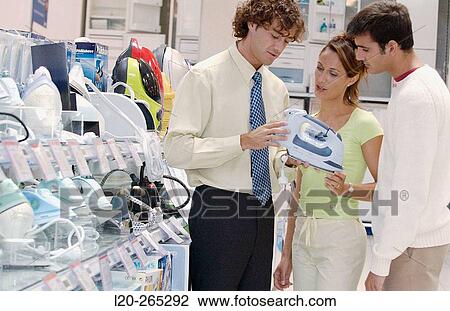 Couple looking for an iron at shopping center View Large Photo Image Stock Image - Couple looking for an iron at shopping center. Fotosearch