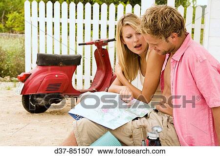 Couple looking up in a map View Large Photo Image Stock Photo - Couple looking up in a map. Fotosearch