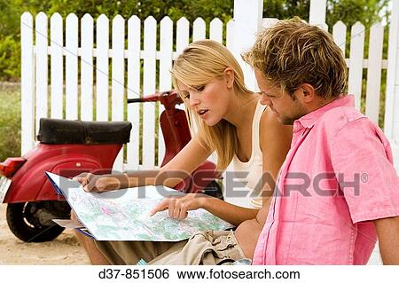 Couple looking up in a map View Large Photo Image Stock Photograph - Couple looking up in a map. Fotosearch