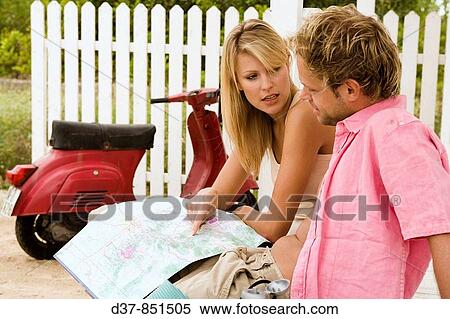 Couple looking up in a map View Large Photo Image Stock Photography - Couple looking up in a map. Fotosearch