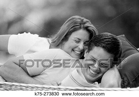 Couple lying down in hammock View Large Photo Image Stock Image - Couple lying down in hammock. Fotosearch