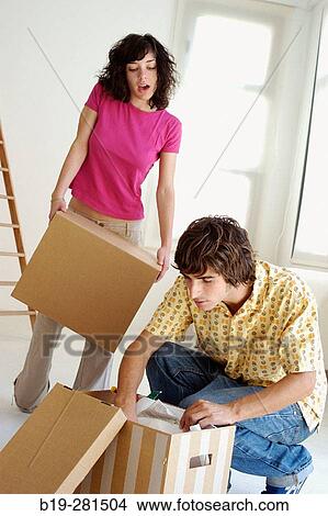 Couple moving home View Large Photo Image Picture - Couple moving home. Fotosearch