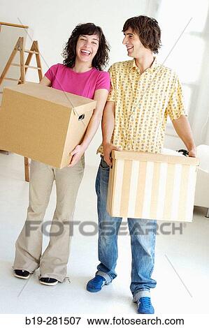 Couple moving home View Large Photo Image Stock Photo - Couple moving home. Fotosearch