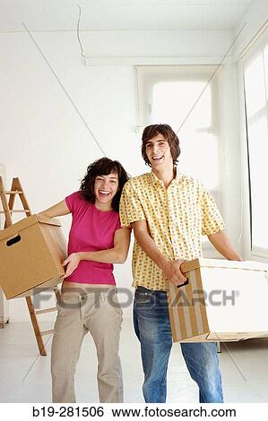 Stock Photograph - Couple moving home. Fotosearch