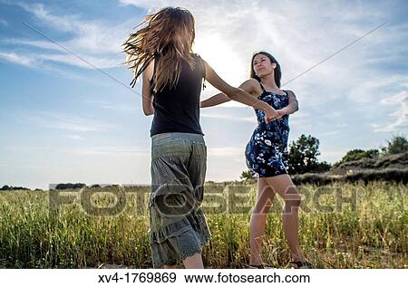 Couple of girls dancing and enjoyment in the countryside View Large Photo Image Stock Photo - Couple of girls dancing and enjoyment in the countryside. Fotosearch