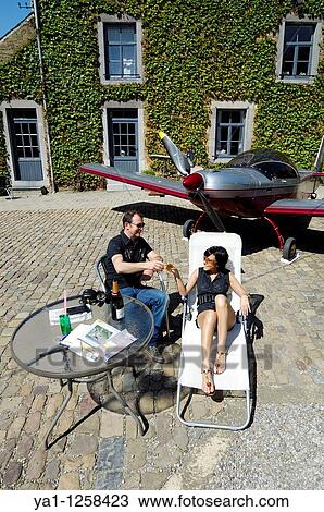 Couple of microlight pilots plane Zenair 601 taking a rest in farm yard after a flight, Belgium View Large Photo Image Stock Image - Couple of microlight pilots plane Zenair 601 taking a rest in farm yard after a flight, Belgium. Fotosearch