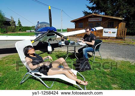 Couple of microlight plane Zenair 601 pilots preparing a flight, Belgium View Large Photo Image Picture - Couple of microlight plane Zenair 601 pilots preparing a flight, Belgium. Fotosearch