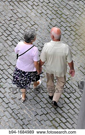 Couple of middle-aged walking View Large Photo Image Stock Photo - Couple of middle-aged walking. Fotosearch