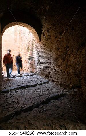 Stock Photograph - Couple of visitors inside Alcazaba, Alhambra, Granada, Spain. Fotosearch