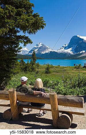 Couple on a bench overlooking, Bow Lake, Icefields Parkway, Alberta, Canada View Large Photo Image Stock Photo - Couple on a bench overlooking, Bow Lake, Icefields Parkway, Alberta, Canada. Fotosearch