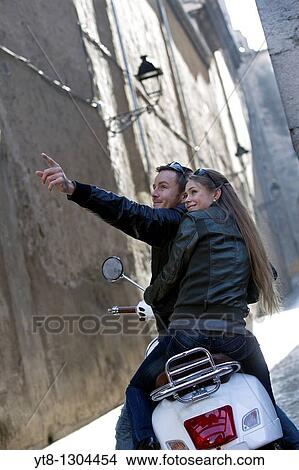 Couple on a motor scooter sightseeing View Large Photo Image Picture - Couple on a motor scooter sightseeing. Fotosearch