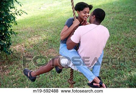 couple on a rope swing View Large Photo Image Stock Photo - couple on a rope swing. Fotosearch
