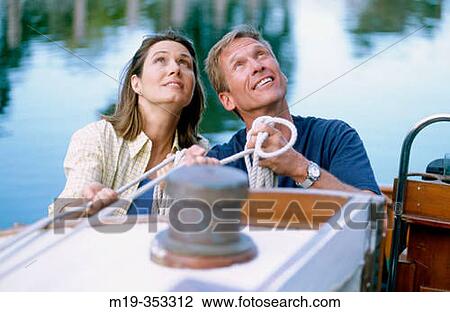 Stock Image - couple on a sailboat. Fotosearch