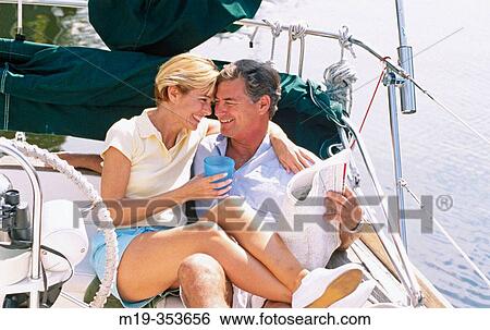Couple on a sailboat View Large Photo Image Stock Photograph - Couple on a sailboat. Fotosearch