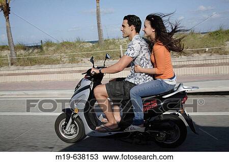 Couple on a scooter View Large Photo Image Stock Image - Couple on a scooter. Fotosearch