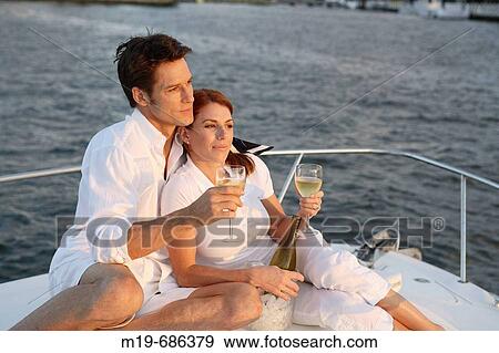 Couple on a sunset cruise View Large Photo Image Stock Photo - Couple on a sunset cruise. Fotosearch