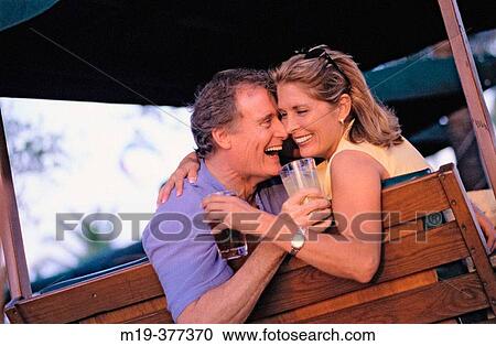 couple on a swing bench having a drink View Large Photo Image Stock Image - couple on a swing bench having a drink. Fotosearch