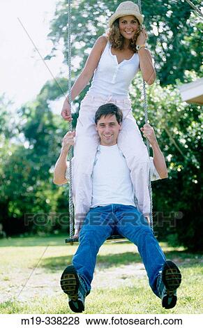 couple on a swing View Large Photo Image Stock Photo - couple on a swing. Fotosearch