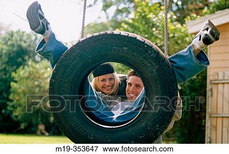 couple on a swing View Large Photo Image Stock Photo - couple on a swing. Fotosearch