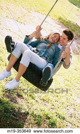 couple on a swing View Large Photo Image Stock Photo - couple on a swing. Fotosearch