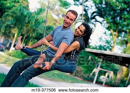 couple on a swing View Large Photo Image Stock Photograph - couple on a swing. Fotosearch