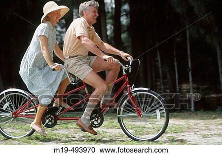 couple on a tandem bike View Large Photo Image Stock Image - couple on a tandem bike. Fotosearch