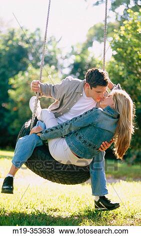 couple on a tire swing kissing View Large Photo Image Stock Photo - couple on a tire swing kissing. Fotosearch