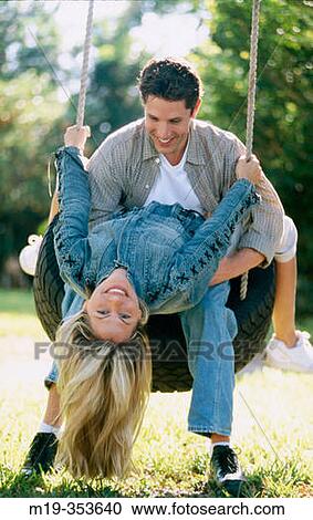 couple on a tire swing View Large Photo Image Stock Image - couple on a tire swing. Fotosearch