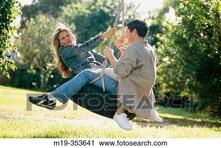 couple on a tire swing View Large Photo Image Stock Image - couple on a tire swing. Fotosearch