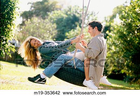 couple on a tire swing View Large Photo Image Stock Image - couple on a tire swing. Fotosearch