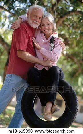couple on a tire swing View Large Photo Image Stock Image - couple on a tire swing. Fotosearch