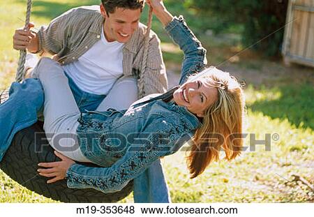 couple on a tire swing View Large Photo Image Stock Photo - couple on a tire swing. Fotosearch
