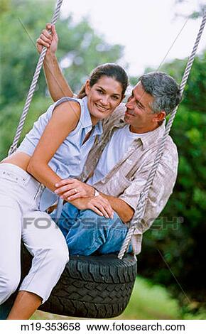 couple on a tire swing View Large Photo Image Stock Photo - couple on a tire swing. Fotosearch