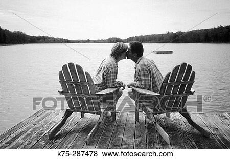 Stock Photo - Couple on Adirondack chairs in dock. Starlight. Poconos. Pennsylvania, USA. Fotosearch