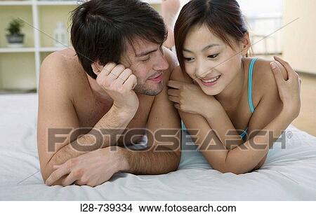 Couple on bed View Large Photo Image Picture - Couple on bed. Fotosearch