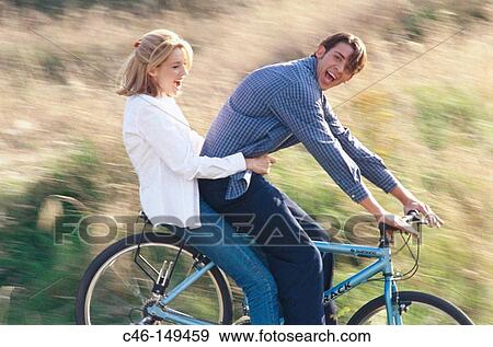 Couple on bicycle View Large Photo Image Stock Photo - Couple on bicycle. Fotosearch