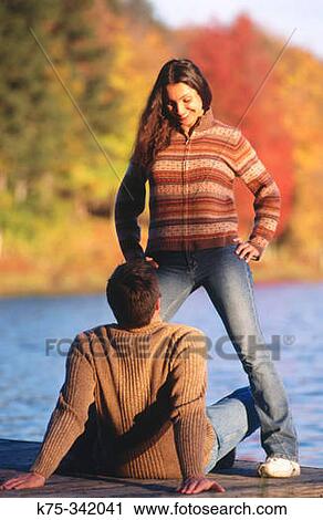 Couple on dock on a lake View Large Photo Image Stock Image - Couple on dock on a lake. Fotosearch