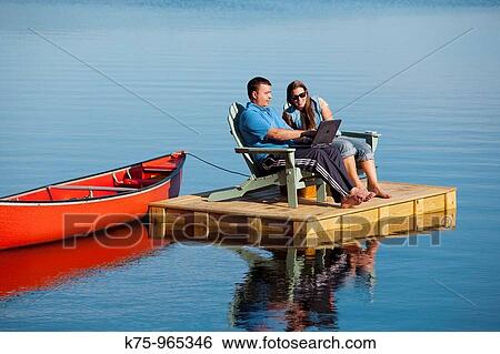 couple on dock with canoe View Large Photo Image Stock Photograph - couple on dock with canoe. Fotosearch