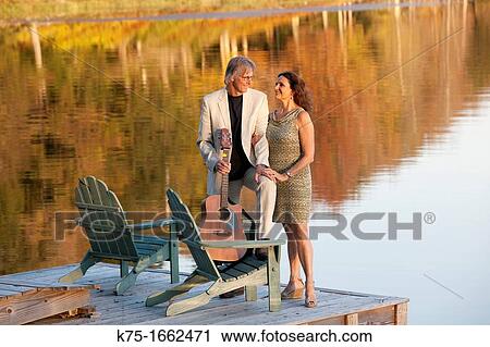 Couple on dock with guitar View Large Photo Image Stock Image - Couple on dock with guitar. Fotosearch