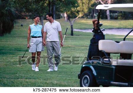 Couple on golf course View Large Photo Image Stock Photography - Couple on golf course. Fotosearch