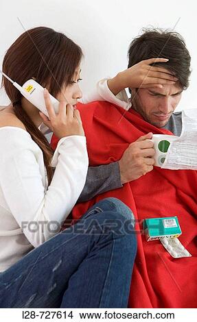 Picture - Couple on sofa. Fotosearch