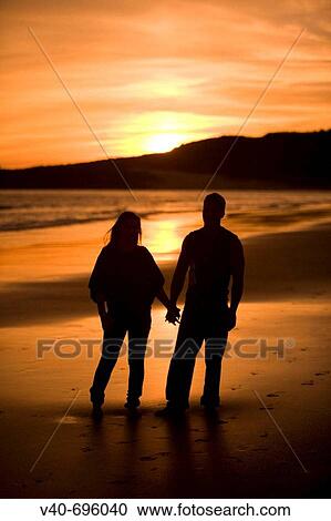 Couple on the beach View Large Photo Image Stock Image - Couple on the beach. Fotosearch