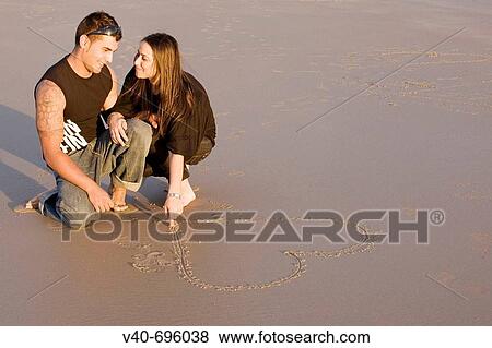 Couple on the beach View Large Photo Image Stock Photo - Couple on the beach. Fotosearch