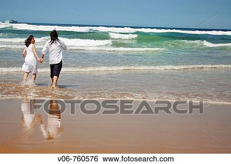 Couple on the beach View Large Photo Image Stock Photograph - Couple on the beach. Fotosearch