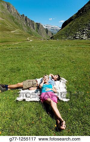 Stock Photo - Couple on the mountain. Italy, Piedmont Alps, Formazza Valley.. Fotosearch