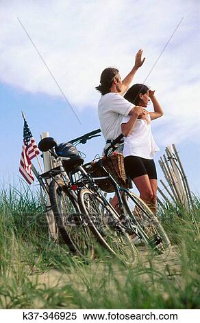 Couple on vacation with bikes on dunes. Nantucket Island. Massachusetts. USA. View Large Photo Image Stock Photography - Couple on vacation with bikes on dunes. Nantucket Island. Massachusetts. USA.. Fotosearch