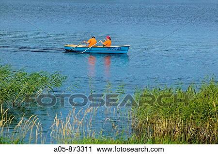Couple paddling in a canoe on Lake Onega, Russia View Large Photo Image Stock Image - Couple paddling in a canoe on Lake Onega, Russia. Fotosearch